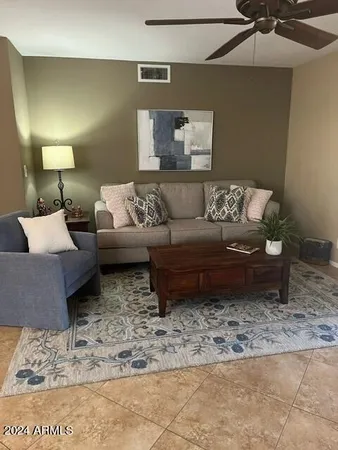 a living room with furniture and a rug