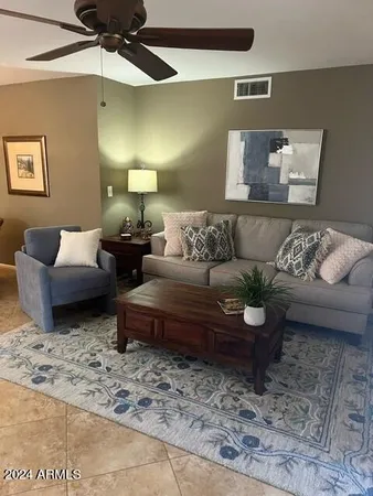 a living room with furniture and a rug