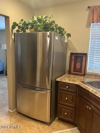a kitchen with a refrigerator and a stove