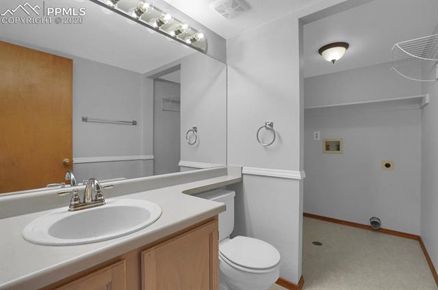 6545 Leesburg Road Colorado Springs, CO 80922 - Photo 10 of 17 Main level 1/2 bath with laundry.