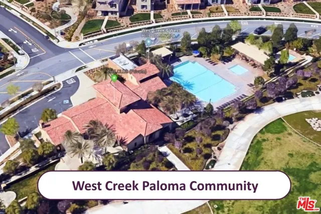 a view of outdoor space with sign board and wooden fence