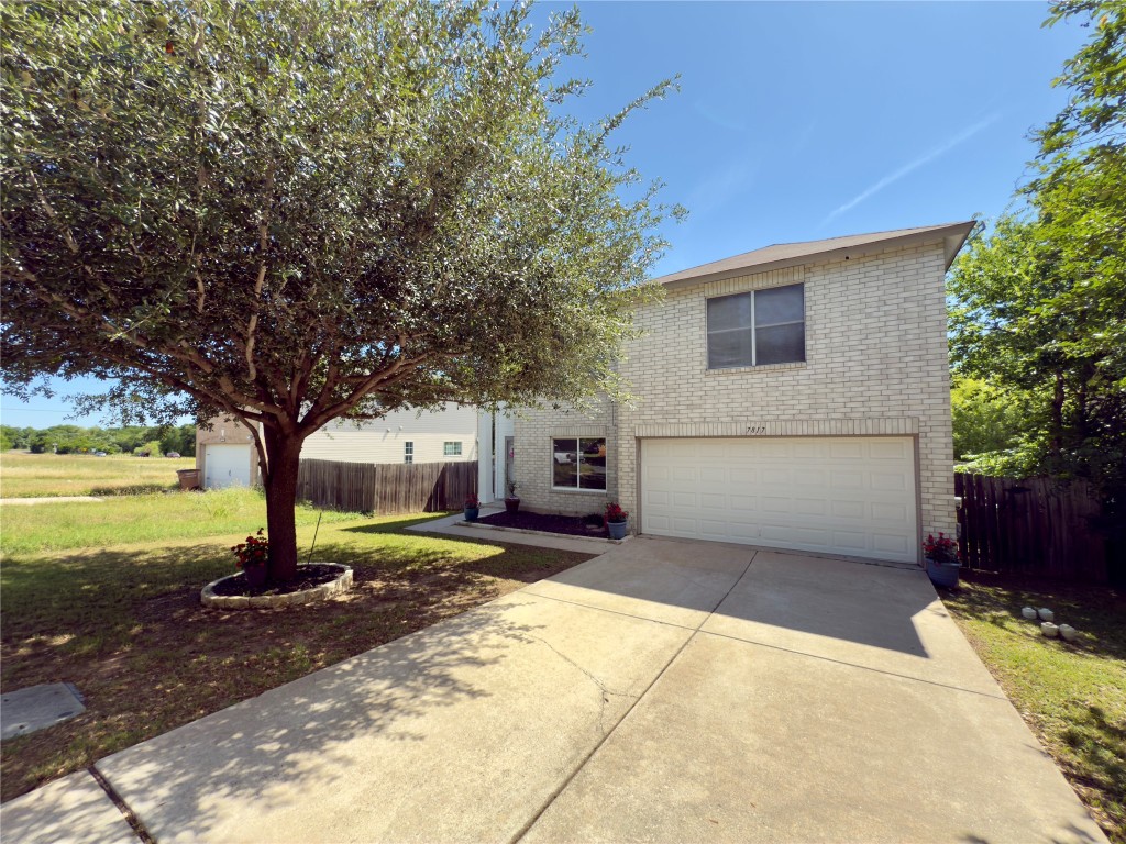 7817 Marble Ridge Drive Austin, TX 78747 - Photo 3 of 38 Traditional home featuring a garage, brick siding, and driveway