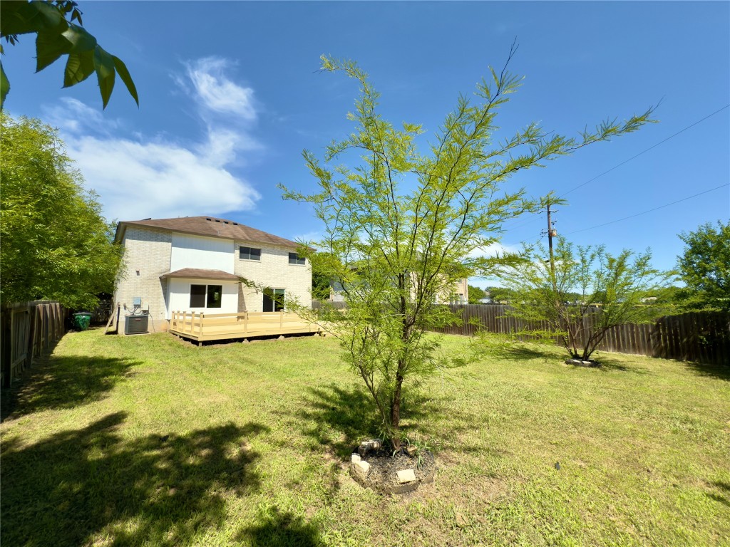 7817 Marble Ridge Drive Austin, TX 78747 - Photo 35 of 38 View of yard featuring a wooden deck and central AC