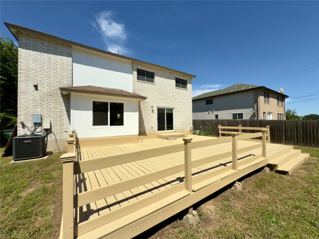 7817 Marble Ridge Drive Austin, TX 78747 - Photo 36 of 38 Back of property featuring central AC unit, a deck, and brick siding