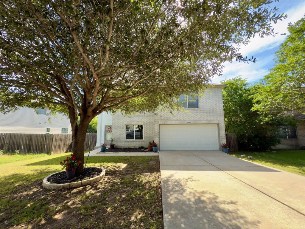 7817 Marble Ridge Drive Austin, TX 78747 - Photo 4 of 38 Obstructed view of property with brick siding, a garage, and concrete driveway