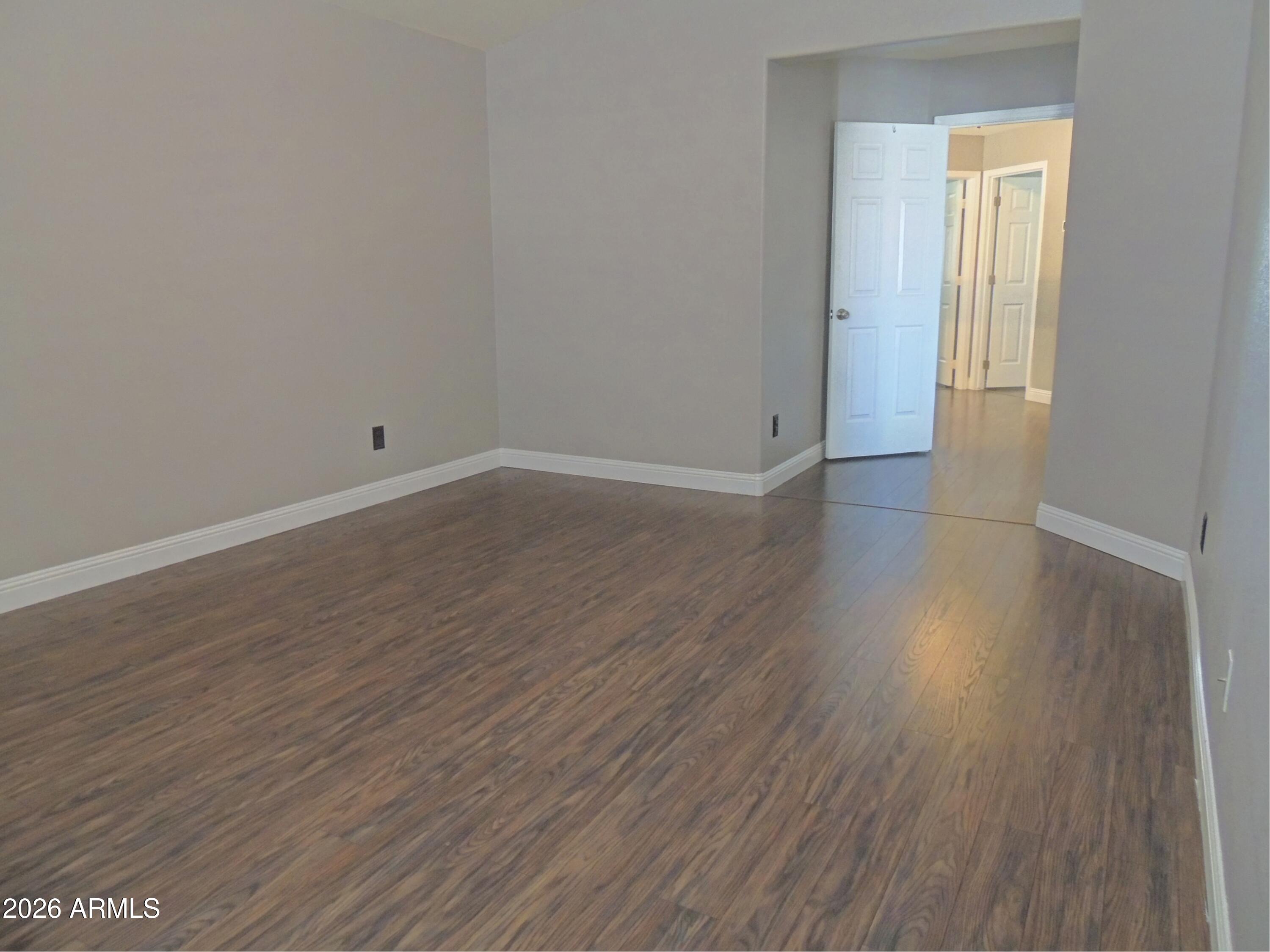 4409 East Dry Creek Road Phoenix, AZ 85044 - Photo 17 of 34 a view of a room with wooden floor and window