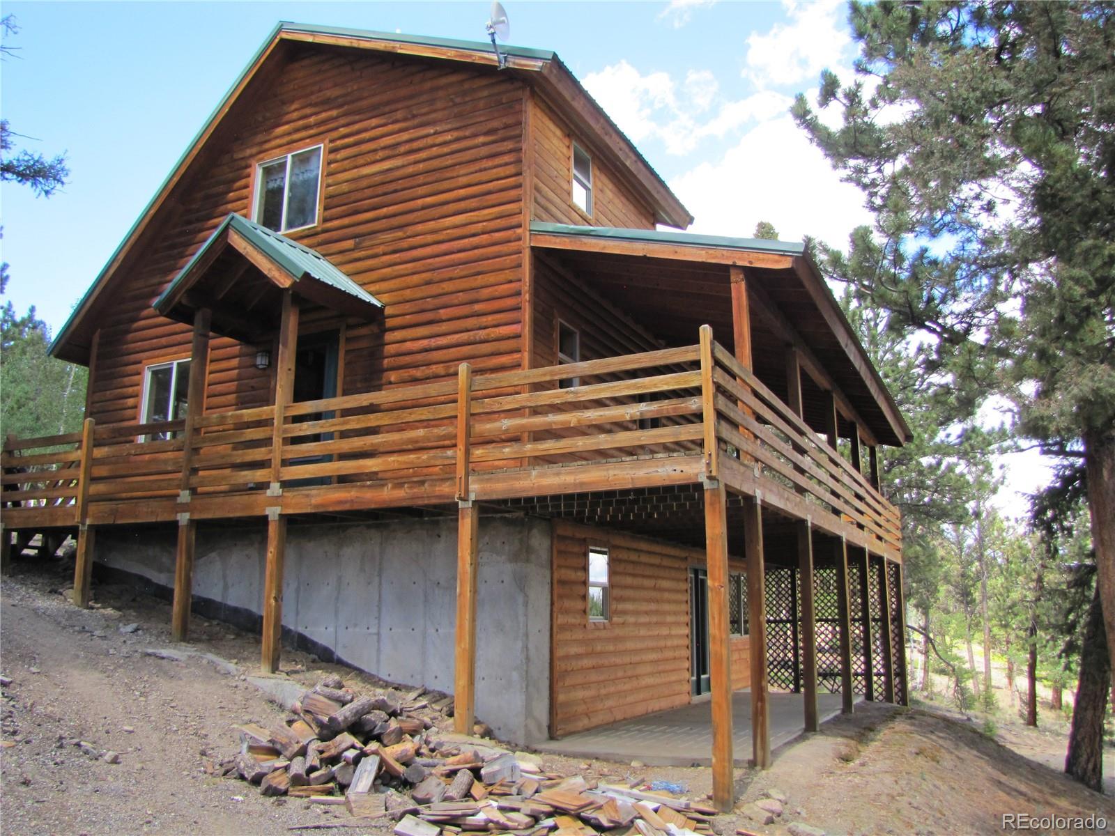 1240 Campfire Road Hartsel, CO 80449 - Photo 1 of 25 a front view of a house with a yard