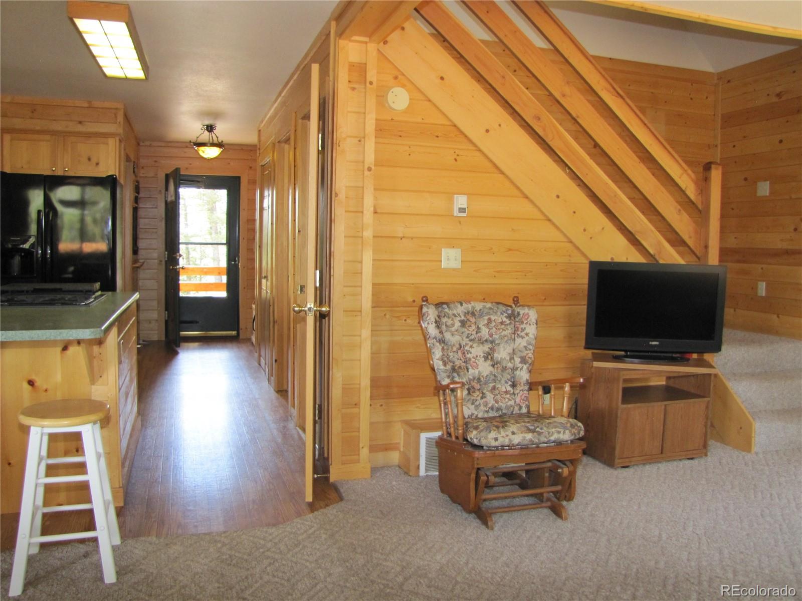 1240 Campfire Road Hartsel, CO 80449 - Photo 12 of 25 a living room with furniture and a flat screen tv