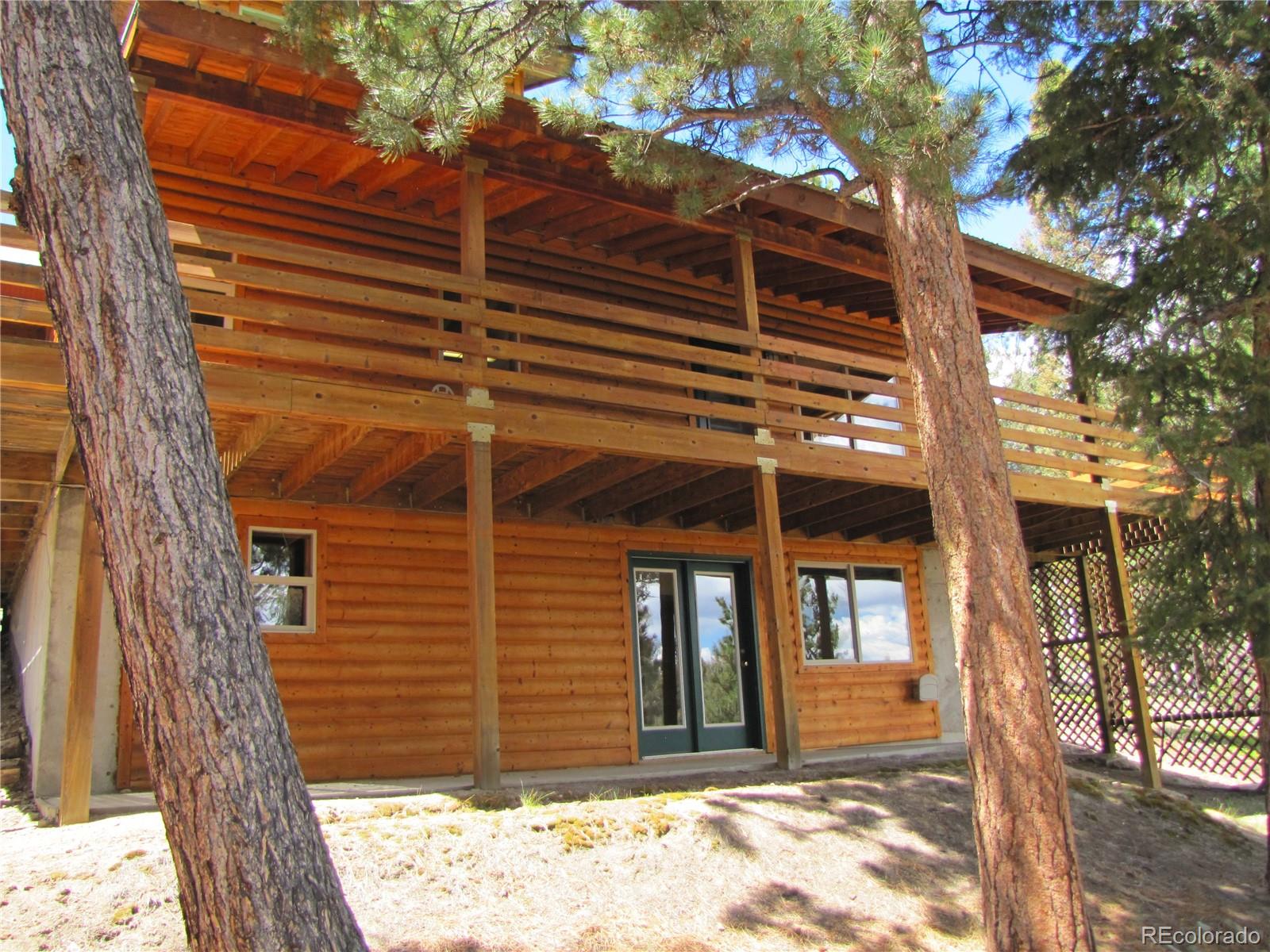 1240 Campfire Road Hartsel, CO 80449 - Photo 22 of 25 a view of a house with a door and wooden walls