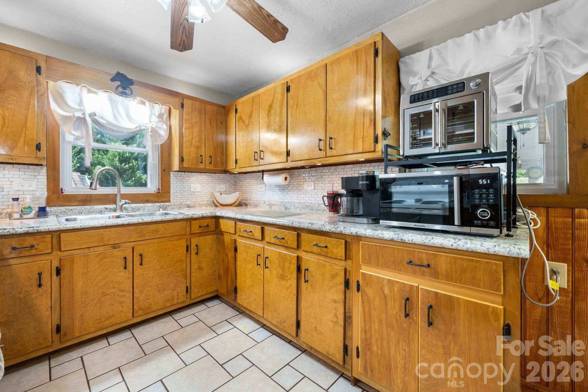 2582 Startown Road Newton, NC 28658 - Photo 11 of 42 a kitchen with stainless steel appliances granite countertop a sink window and cabinets