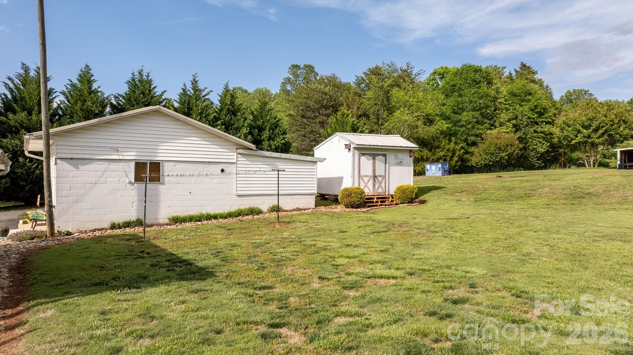 2582 Startown Road Newton, NC 28658 - Photo 21 of 42 a house with green field in front of it