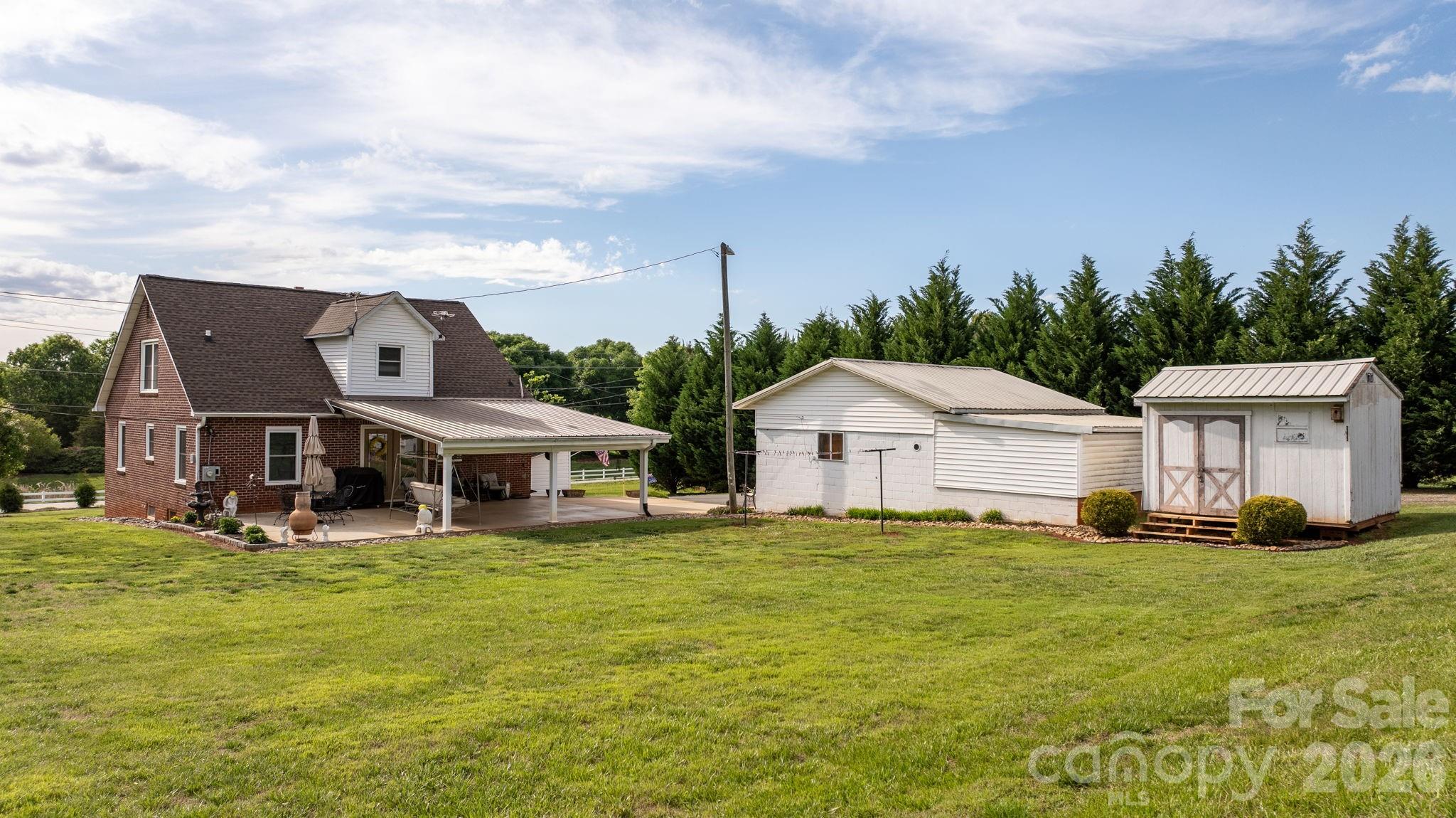 2582 Startown Road Newton, NC 28658 - Photo 25 of 42 a big white house with a big yard and large trees