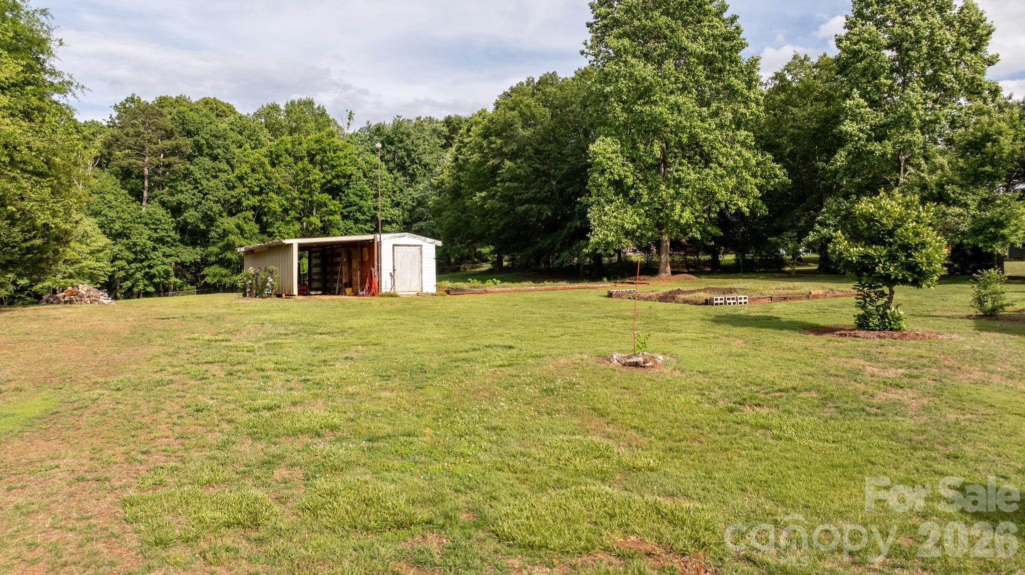 2582 Startown Road Newton, NC 28658 - Photo 27 of 42 a view of a swimming pool with an outdoor seating and a yard