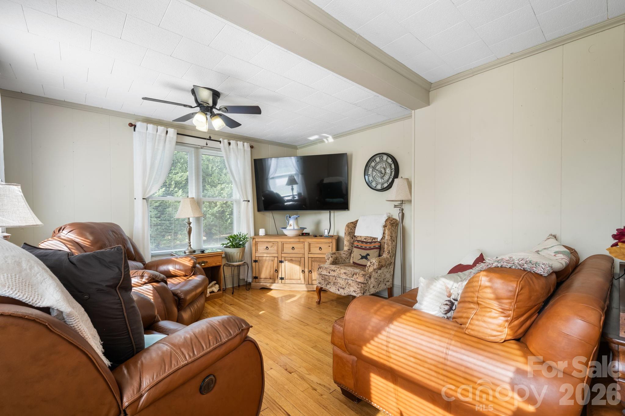 2582 Startown Road Newton, NC 28658 - Photo 7 of 42 a living room with furniture ceiling fan and a flat screen tv
