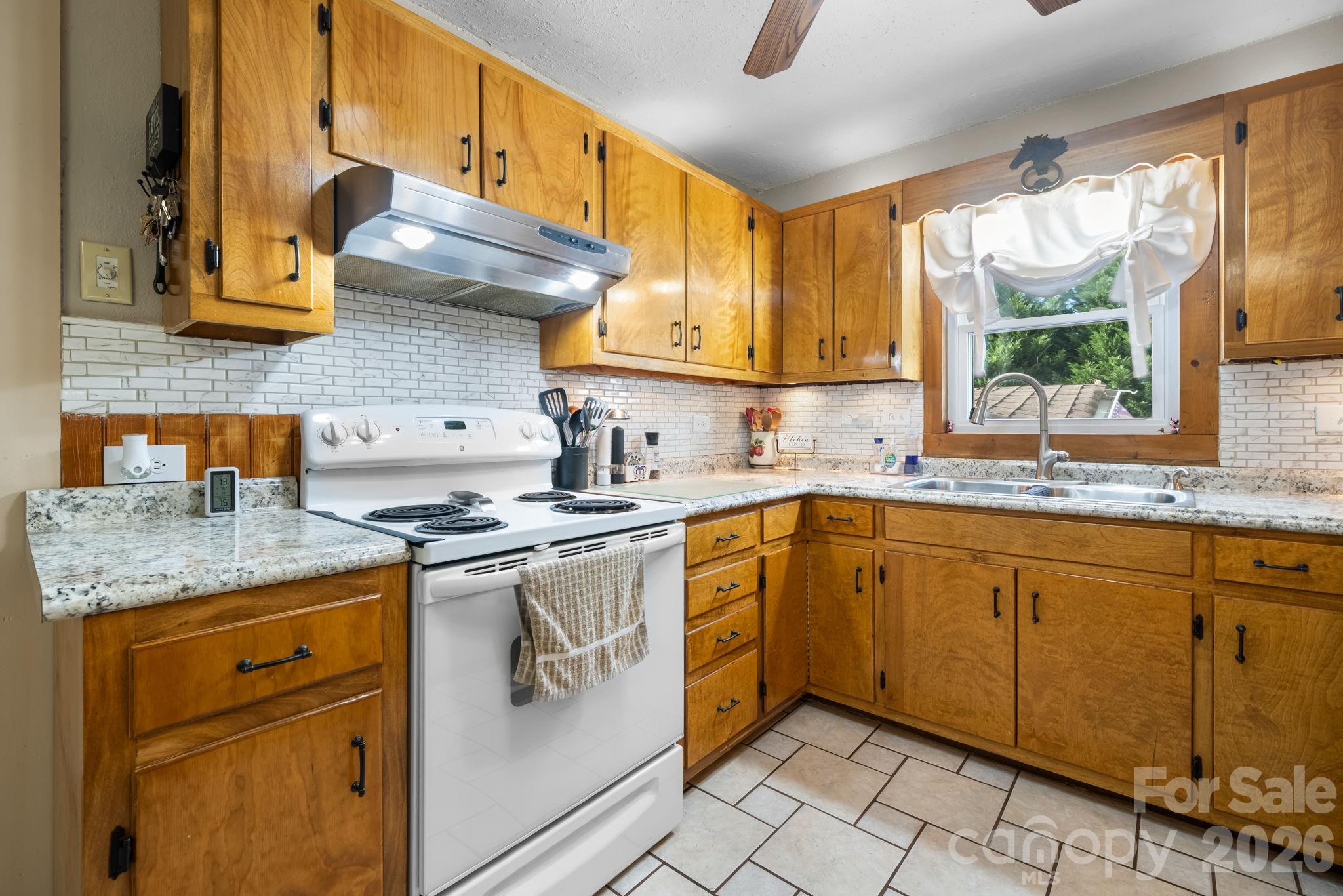 2582 Startown Road Newton, NC 28658 - Photo 10 of 42 a kitchen with stainless steel appliances granite countertop a sink stove and cabinets