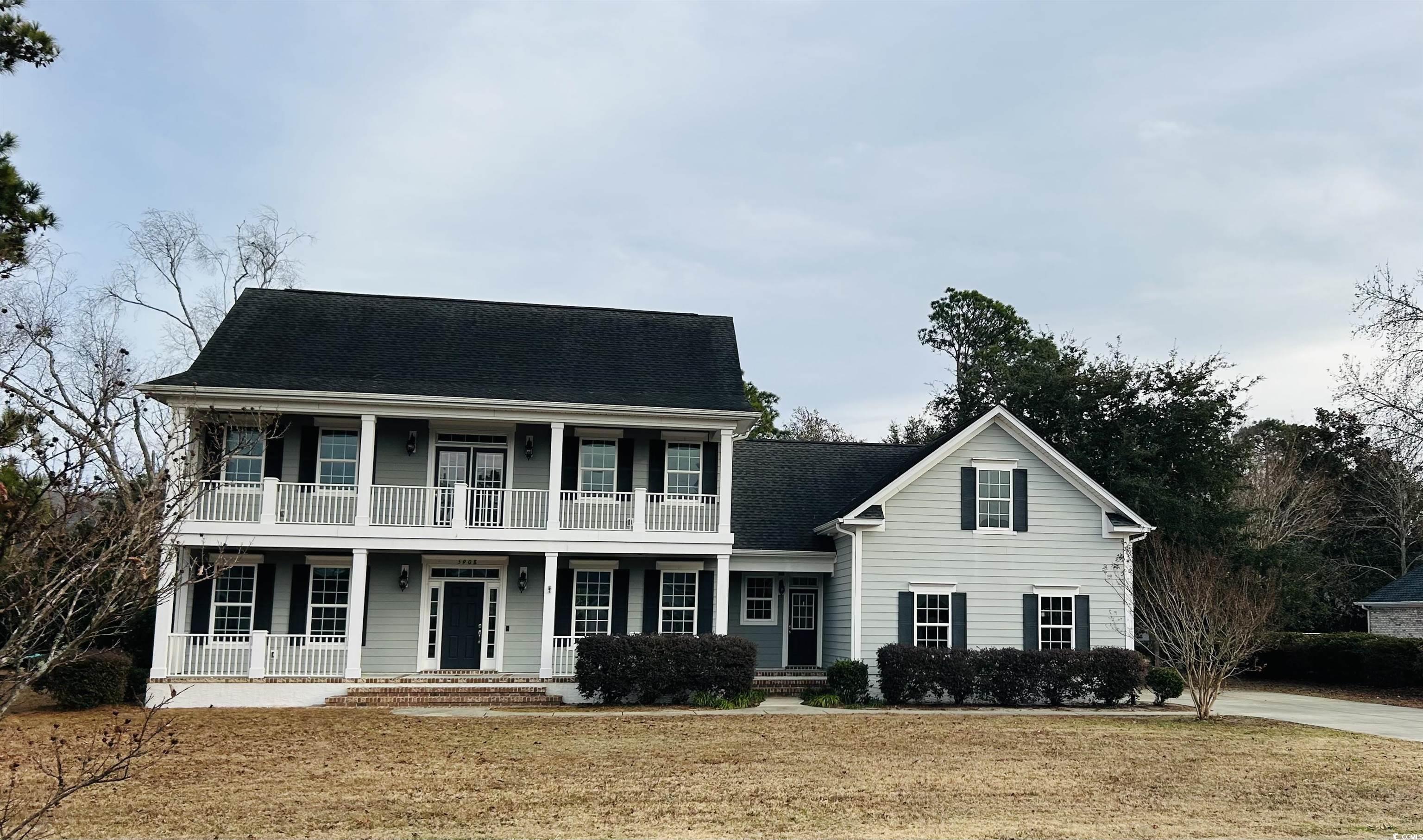 View of front of house featuring covered porch and roof with shingles