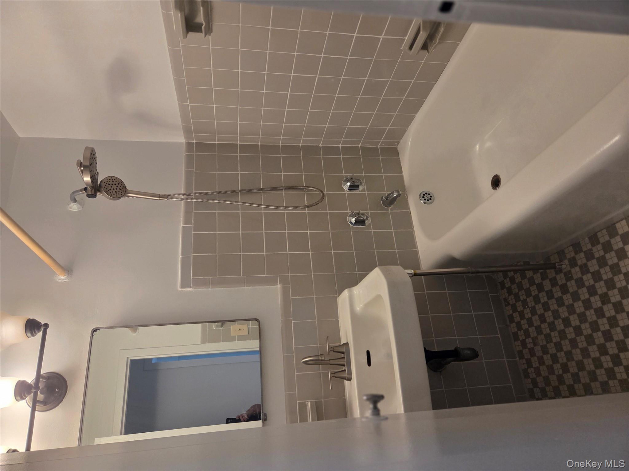 7 Fordham Hill Ovl, Unit 12G Bronx, NY 10468 - Photo 11 of 18 a bathroom with a bathtub a sink a mirror and a shower