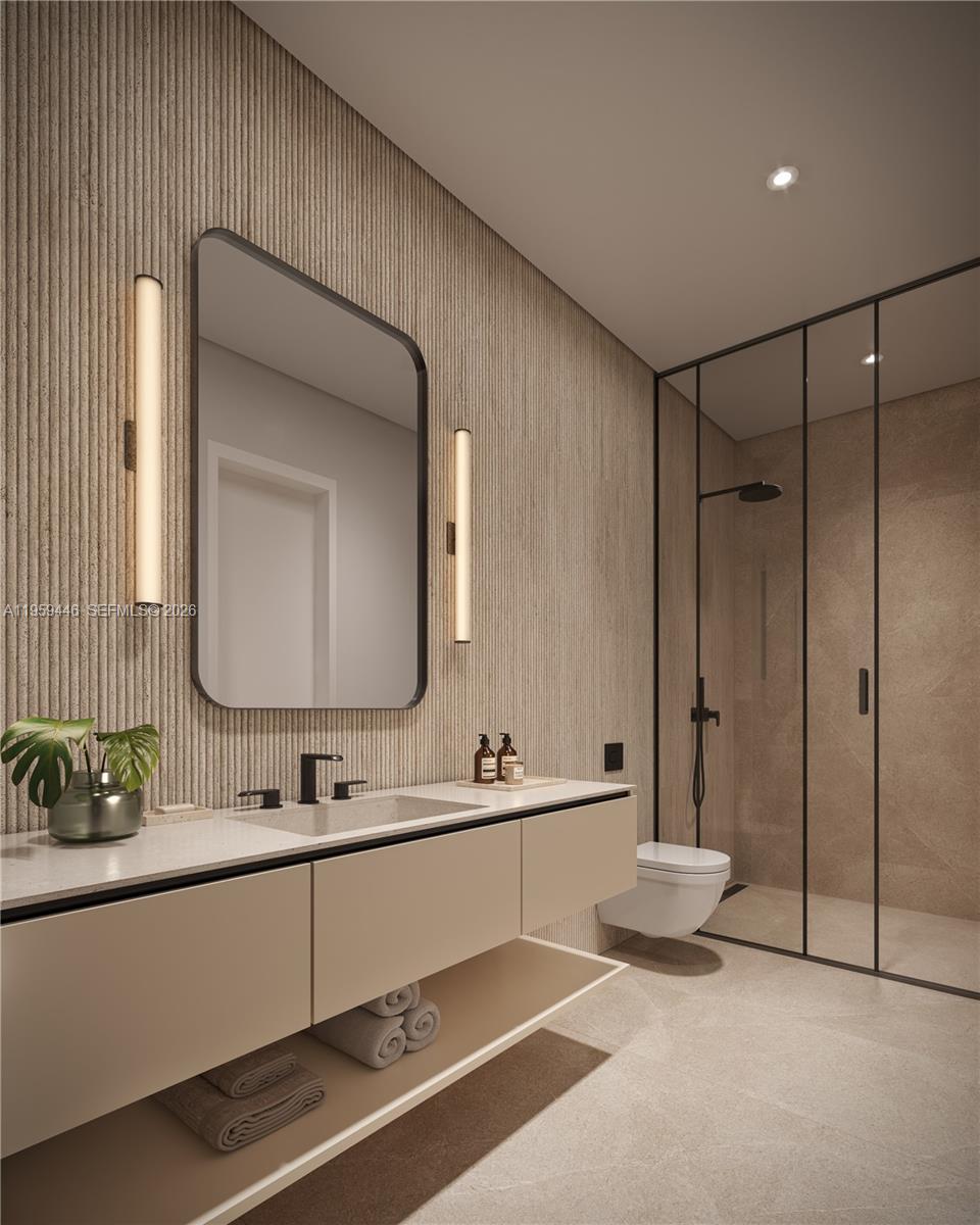 1880 Brickell Avenue, Unit 37 Miami, FL 33129 - Photo 5 of 11 a bathroom with a double vanity sink mirror and bathtub