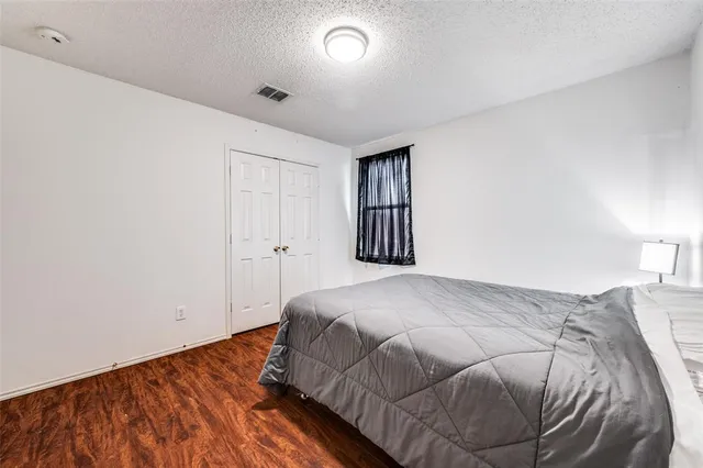 a bedroom with a bed and a lamp