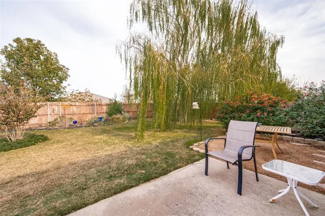 a wooden bench sitting in middle of a yard