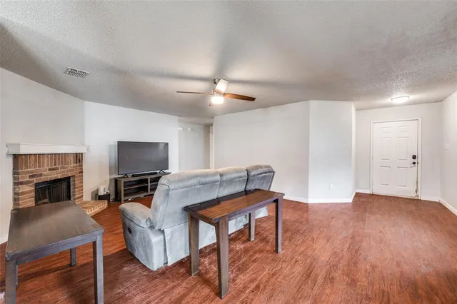 a living room with furniture a fireplace and a flat screen tv