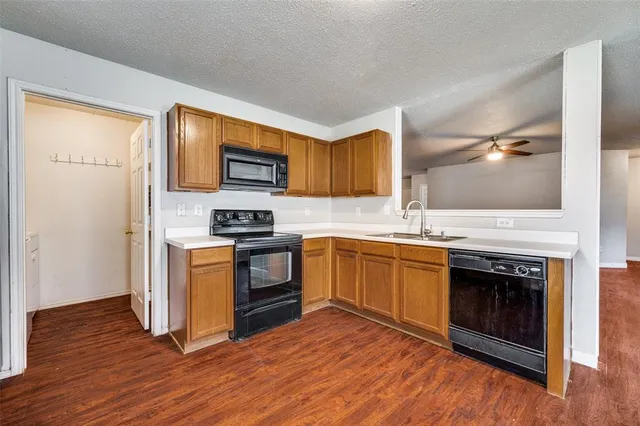 a kitchen with granite countertop a stove top oven and sink
