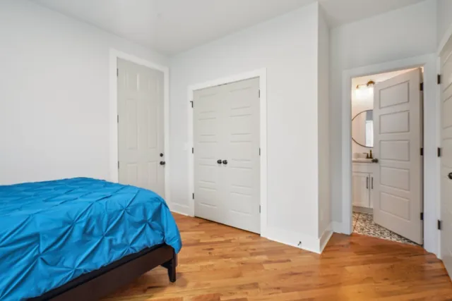 a bedroom with a bed and a mirror