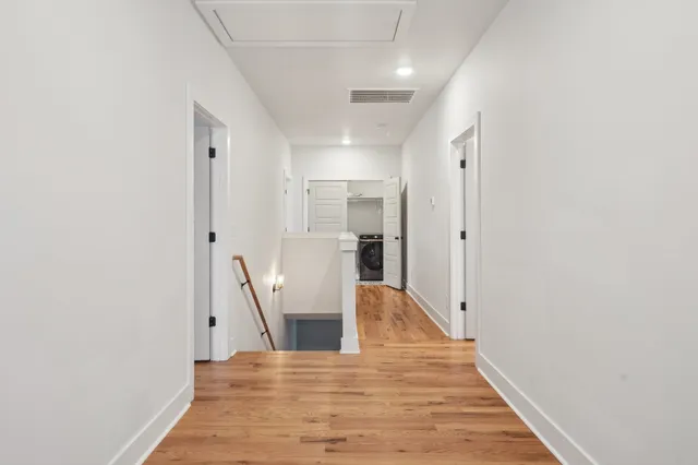 a view of a kitchen with wooden floor and a refrigerator