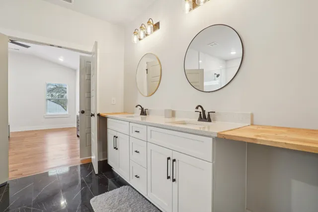 a spacious bathroom with a double vanity sink and a mirror