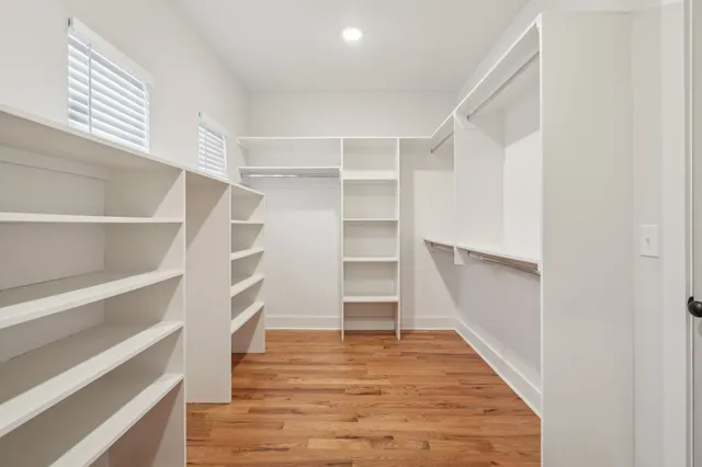 a view of walk in closet with empty racks