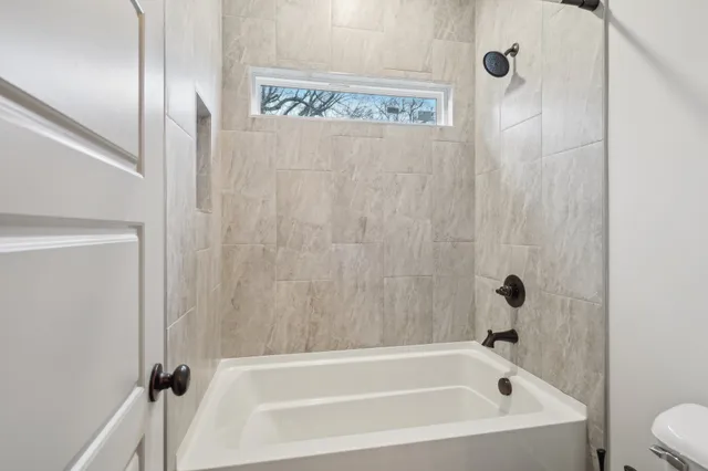 a white bath tub sitting next to a white sink