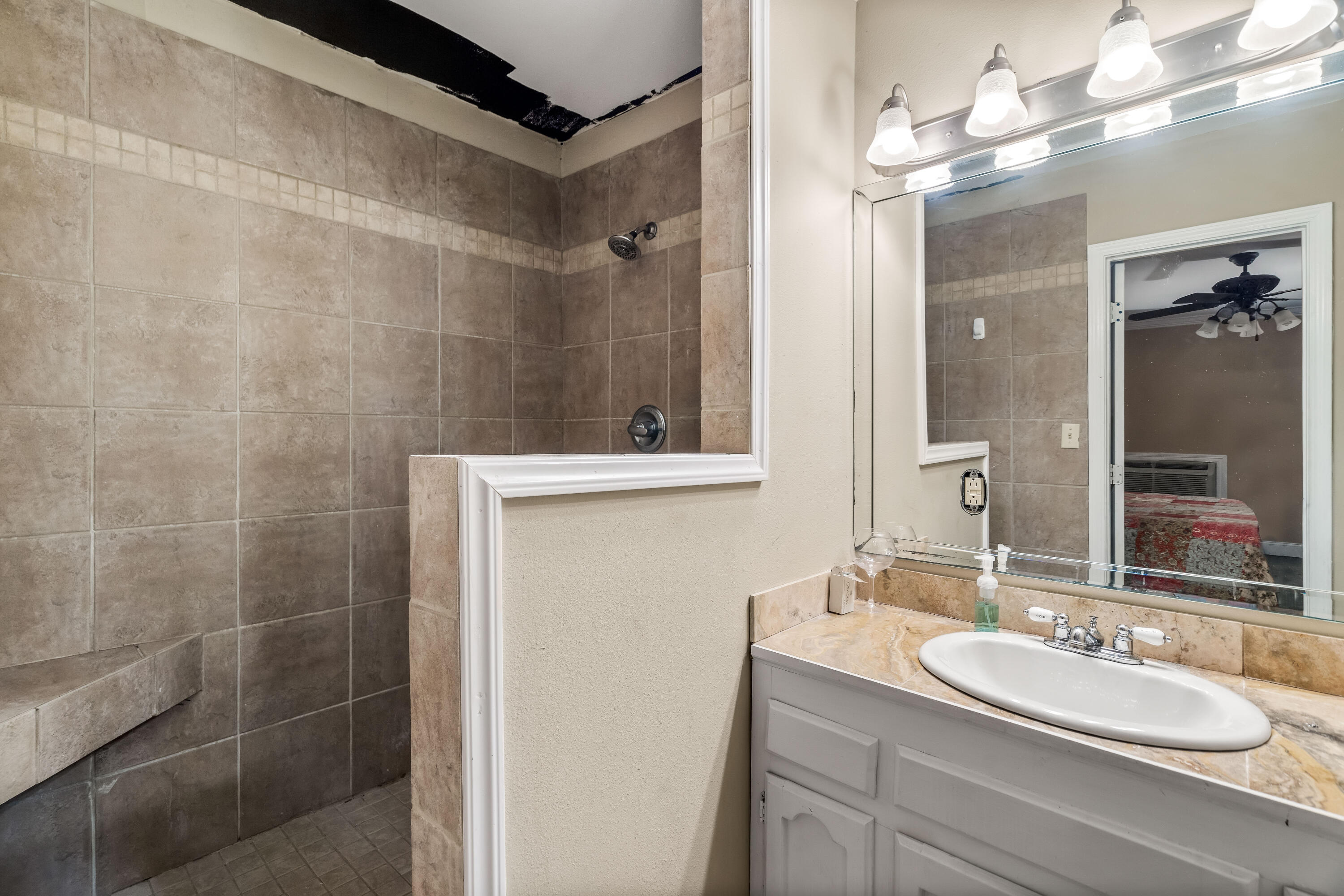 200 Beach Drive West Miramar Beach, FL 32550 - Photo 12 of 45 a bathroom with a double vanity sink mirror and shower