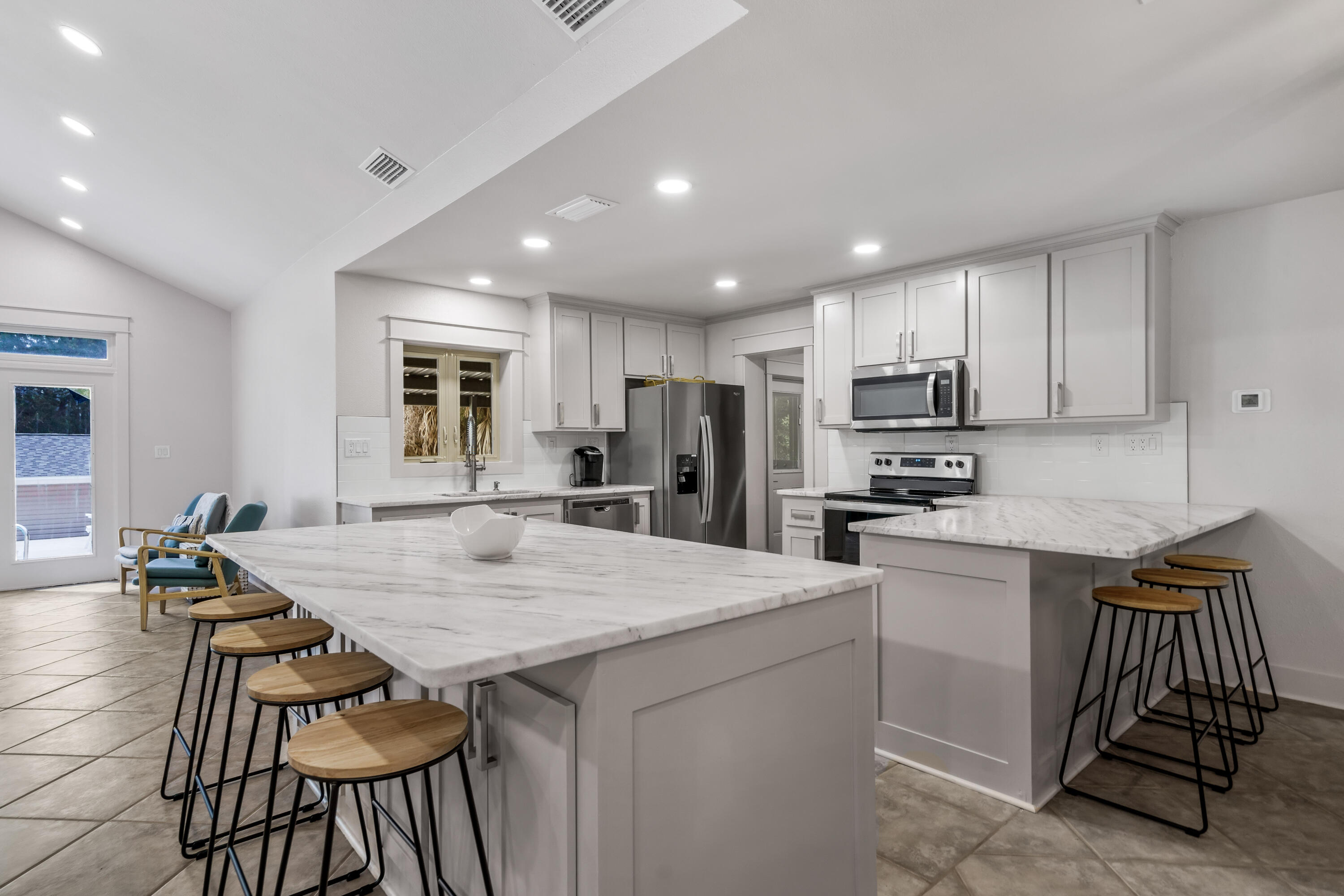 200 Beach Drive West Miramar Beach, FL 32550 - Photo 17 of 45 a kitchen with a table chairs sink and refrigerator