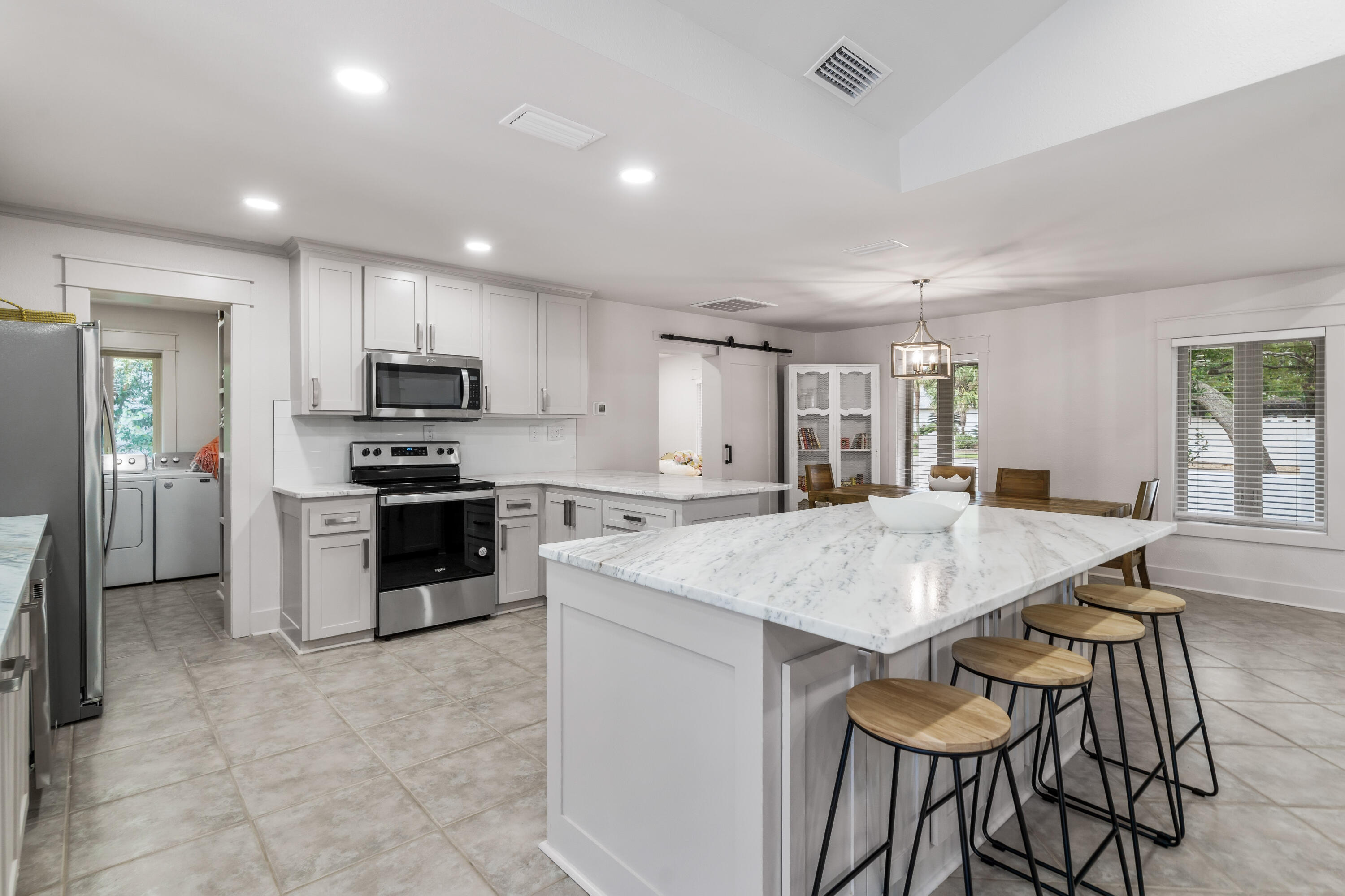 200 Beach Drive West Miramar Beach, FL 32550 - Photo 24 of 45 a large kitchen with kitchen island a table and chairs