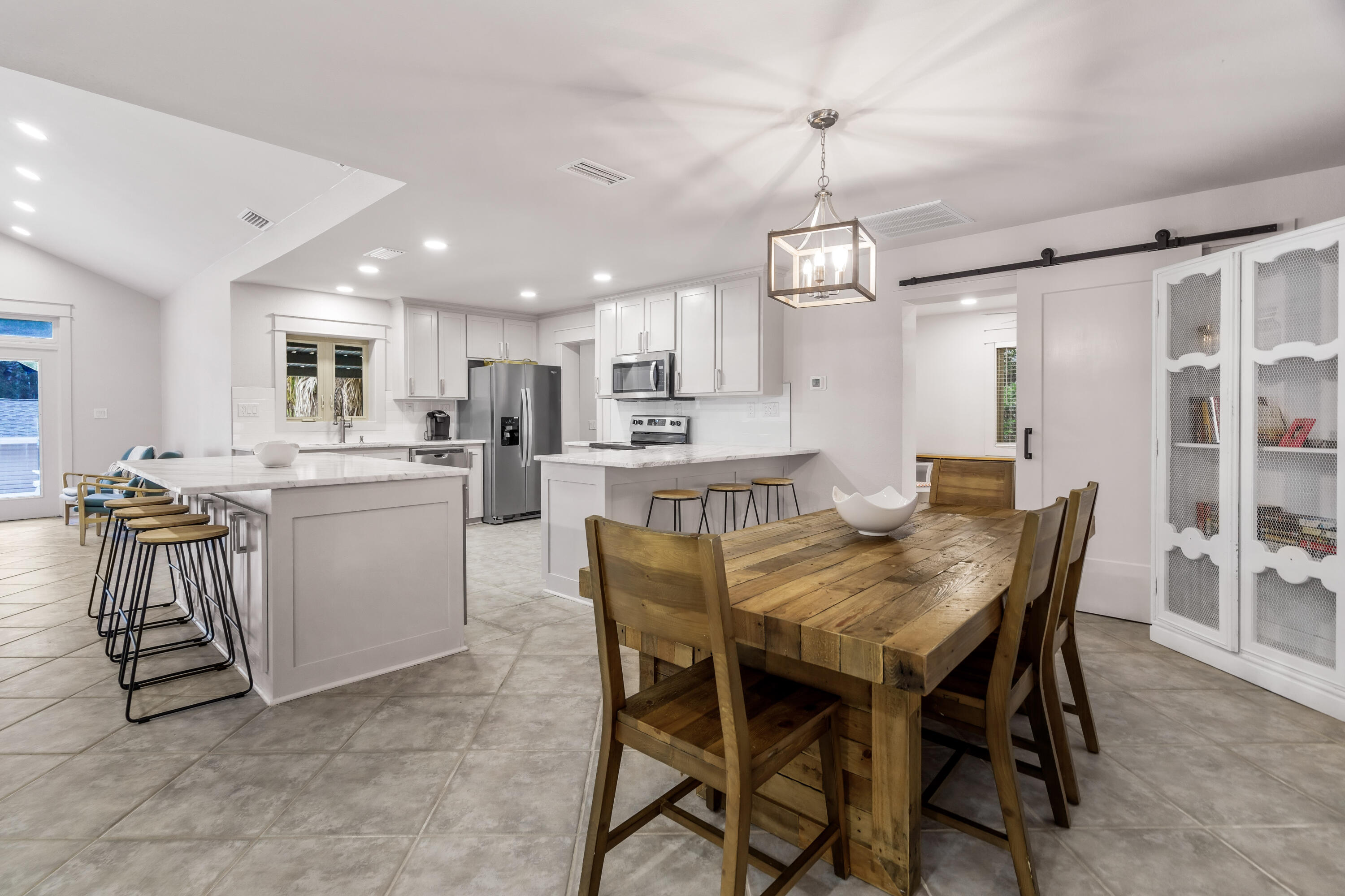 200 Beach Drive West Miramar Beach, FL 32550 - Photo 26 of 45 a kitchen with a table chairs refrigerator and cabinets