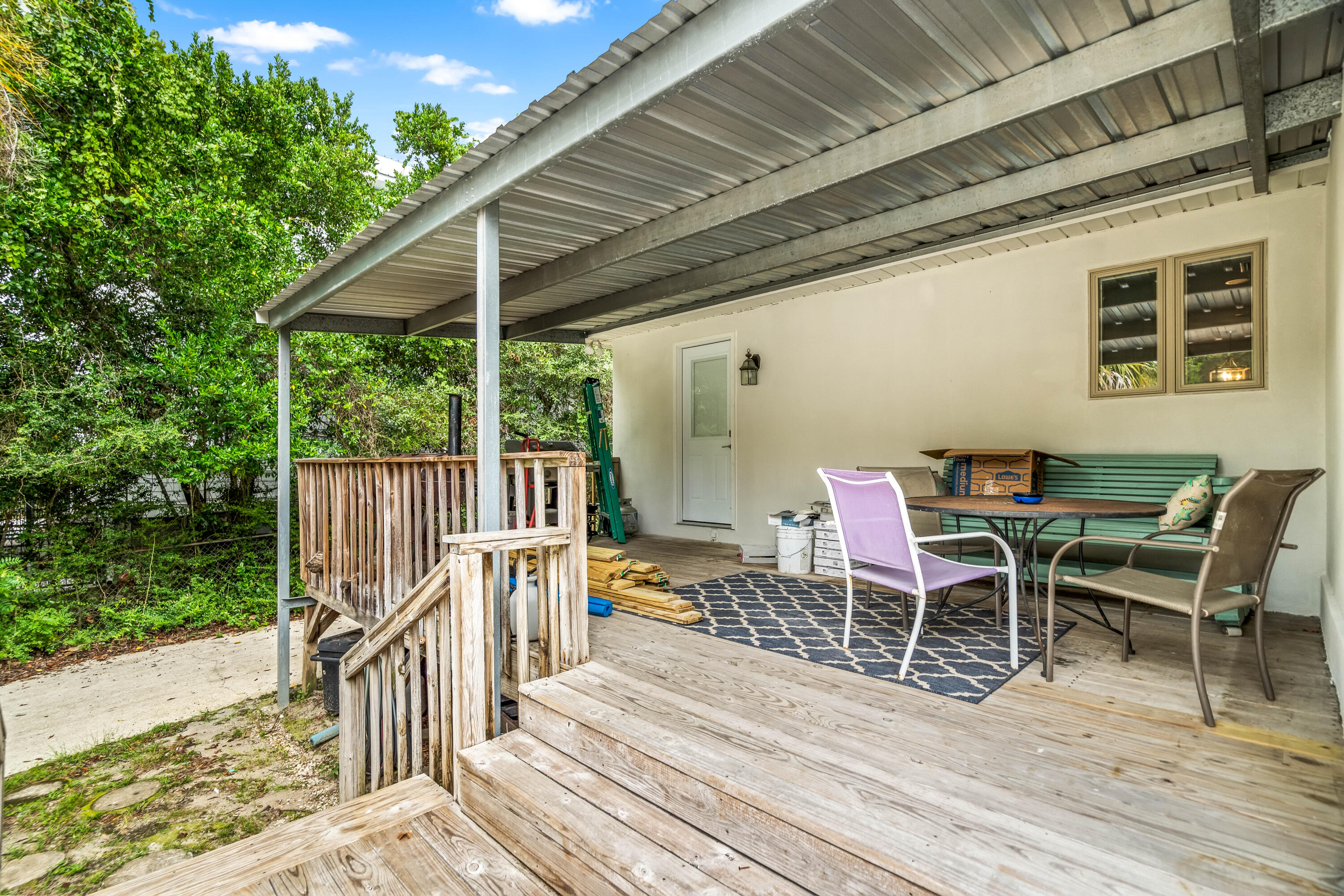 200 Beach Drive West Miramar Beach, FL 32550 - Photo 8 of 45 a view of a chairs and table on the wooden deck
