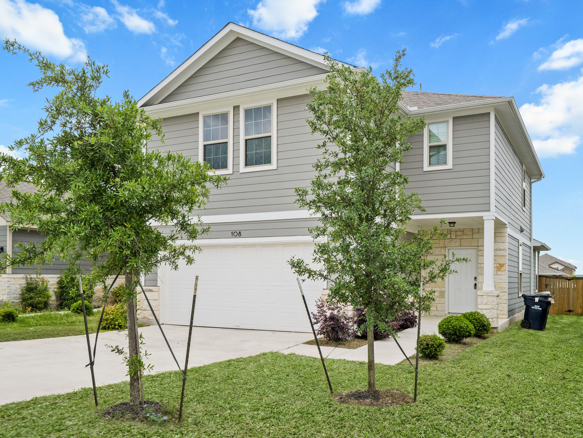 108 Drifter Lane Jarrell, TX 76537 - Photo 1 of 6 Two-story residence featuring gray horizontal siding and a stone facade