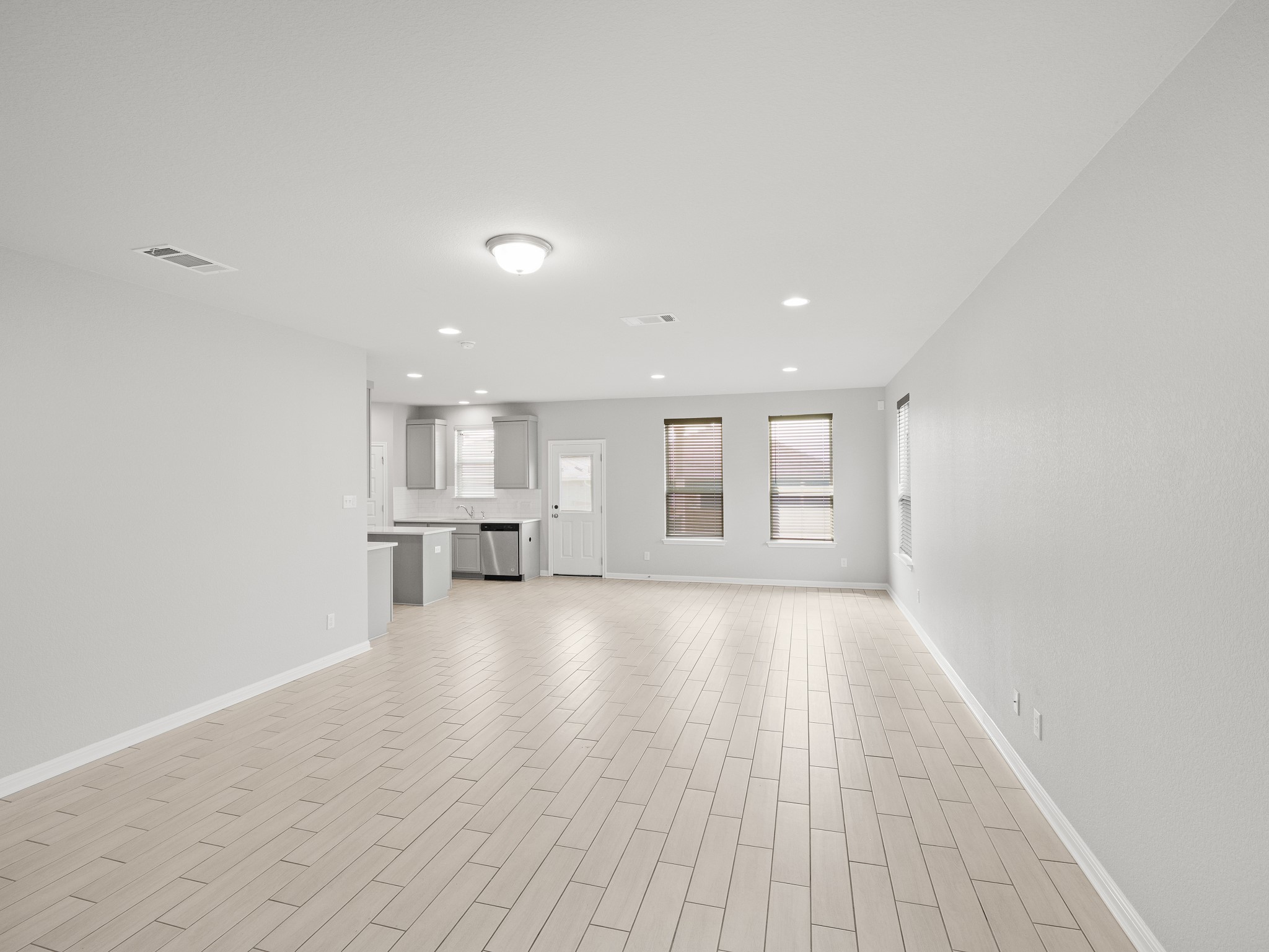 108 Drifter Lane Jarrell, TX 76537 - Photo 2 of 6 Open-concept living area with light-toned wood-finish flooring