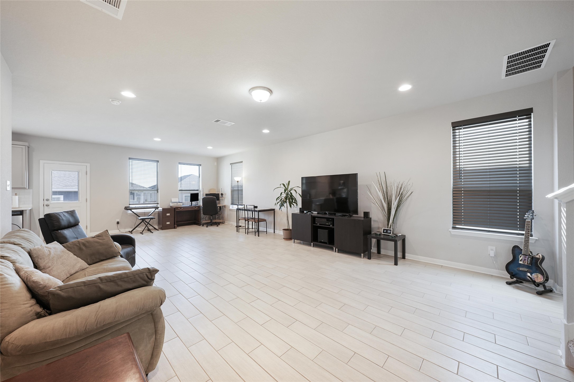 108 Drifter Lane Jarrell, TX 76537 - Photo 5 of 12 Living area featuring wood finish floors, recessed lighting, and an office area
