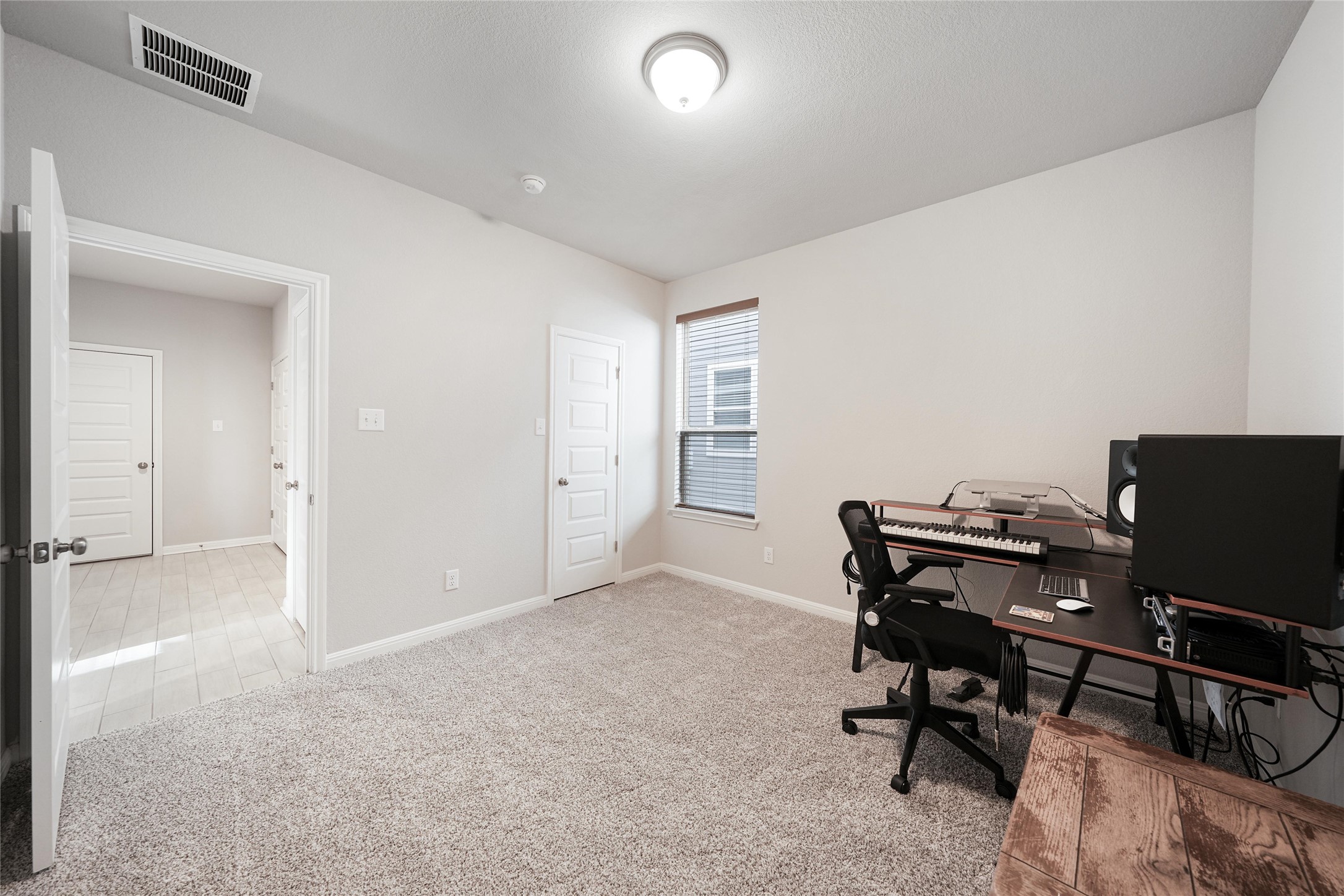 108 Drifter Lane Jarrell, TX 76537 - Photo 8 of 12 Home office with light carpet and baseboards