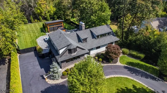 an aerial view of a house with garden space and street view