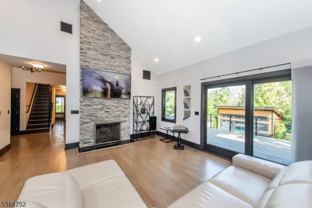 a living room with furniture large window and a fireplace
