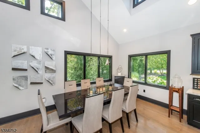 a dining room with furniture a chandelier and wooden floor
