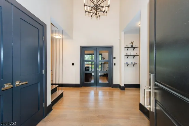 a view of a hallway with bathroom and shower