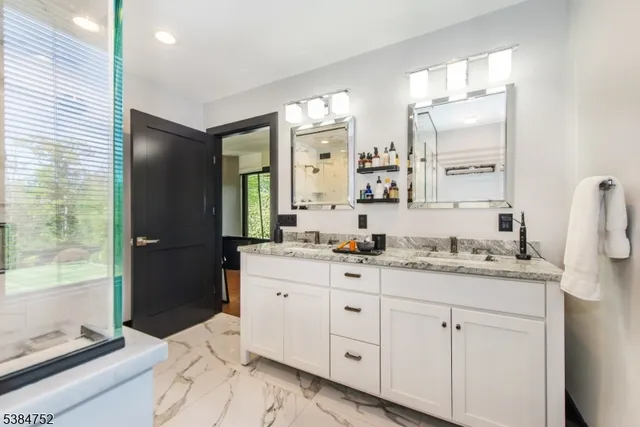 a bathroom with a granite countertop sink mirror and a