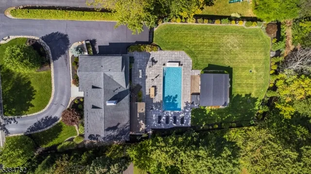 an aerial view of a house with swimming pool outdoor seating and yard