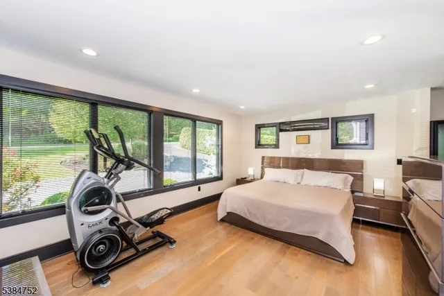 a bedroom with a bed and a view of balcony