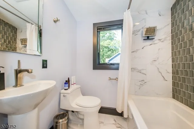 a bathroom with a sink toilet and bathtub