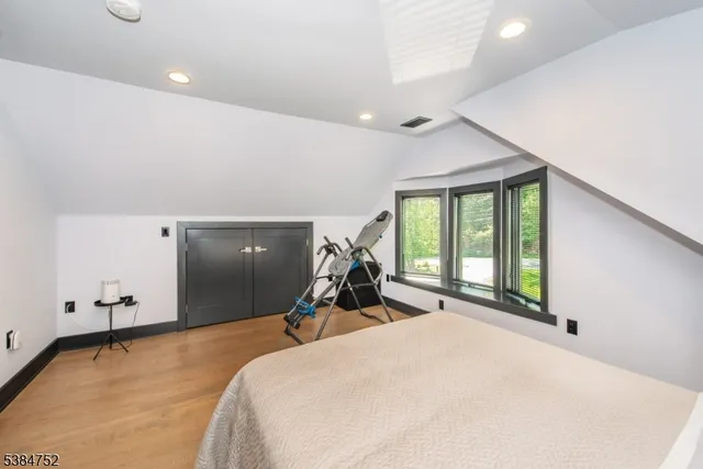 a bed room with a bed and a large window