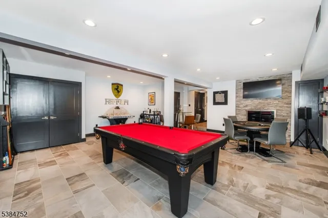 a living room with a pool table and furniture